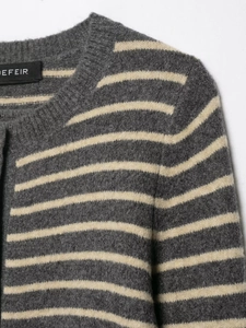 Detailed view of the gray and white striped knit cardigan texture and ribbed neckline