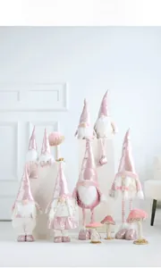 Detailed view of pink and white plush Christmas gnomes with shiny hats and fur beards