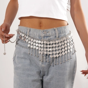 Detail of bohemian layered silver coin fringe waist chain with decorative metallic discs