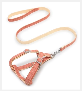 Detailed view of the coral pink plaid dog harness with durable nylon webbing and metal clasp