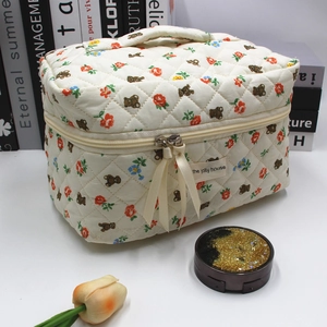 Quilted makeup bag detail featuring cute bear floral pattern and dual zipper closure