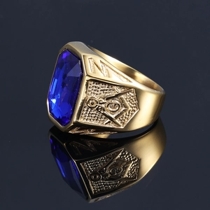 Macro detail of gold Freemason signet ring with blue gemstone and side engraving
