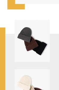 Detailed view of ribbed knit beanies showing thick texture in gray, brown, black and cream