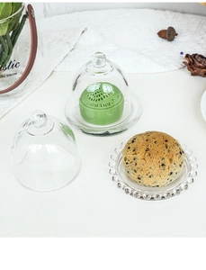 Detail of European crystal glass cake dome with beaded edge tray and round handle top
