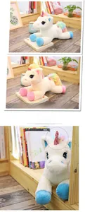 Detail of plush unicorn toy showing rainbow mane and embroidered eyes on bookshelf