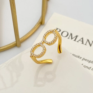 Detail of adjustable gold ring featuring a twin-circle design with white zircon stones