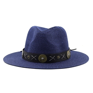 Detail of navy blue straw fedora with black leather belt and vintage bronze metal accents