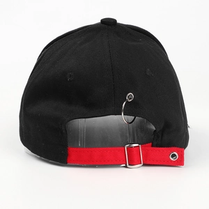 Detail view of black baseball cap featuring red strap, metal buckle and silver ring