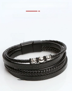 Close-up of 21cm black braided leather bracelet with steel beads and magnetic buckle