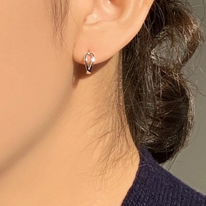 Minimalist silver 925 sterling silver U-shaped hoop earrings worn by a model