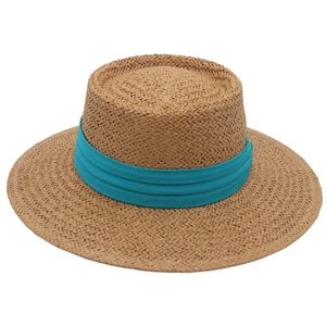 Close-up of fine weave detail and teal ribbon on a natural boater straw hat