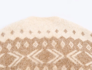 Detail of beige and brown geometric jacquard knit sweater with soft wool texture