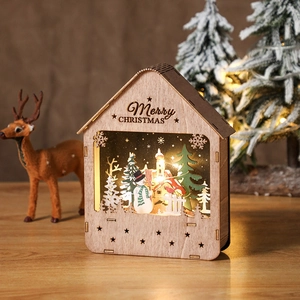 LED lighted wooden Christmas cabin with Merry Christmas engraving and warm glow