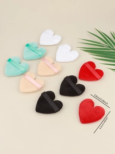 Close-up of colorful heart-shaped velour powder puffs with ribbon straps and size details