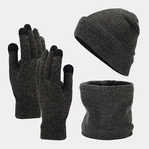 Flat lay of gray winter knit set including a beanie, touch screen gloves and neck warmer