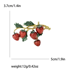 Elegant strawberry brooch in red enamel and gold finish with size and weight dimensions