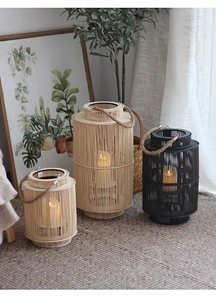 Detail of three Nordic handwoven bamboo lanterns with LED candles and jute rope handles