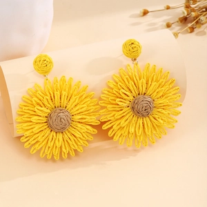 Detail showing the intricate woven texture and craftsmanship of sunflower earrings
