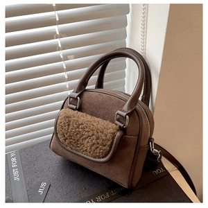Detail of plush brown tote bag with fuzzy lamb wool pocket and suede texture