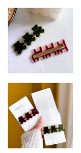 Detailed view of bear-shaped and wave hair clips in green, pink, and brown finishes