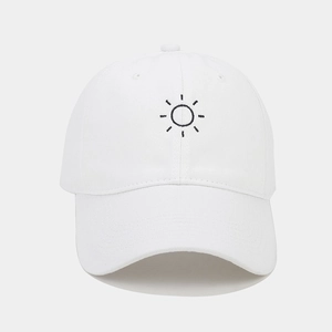 Close-up of white cotton baseball cap with sun embroidery detail and curved brim