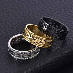 Macro shot of silver gold and black steel rings with double rope and Cuban link design