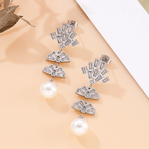 Detail of silver long drop earrings with micro-inlaid zircon and white round pearls
