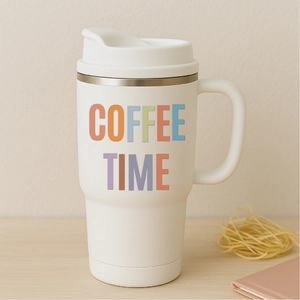 Close-up of white insulated coffee mug with COFFEE TIME print on wooden tabletop