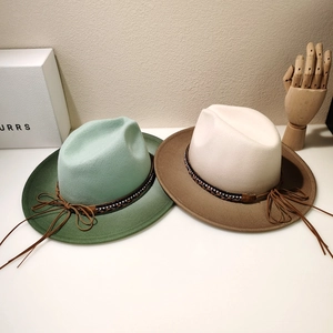 Detail of color-block fedora hats with woven leather bands and rhinestone accents