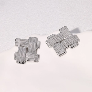 Vintage silver woven square earrings in stainless steel on a white textured tray