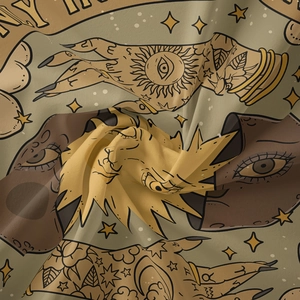 Detail of tarot tapestry fabric showing palmistry hand and mystical sun symbols