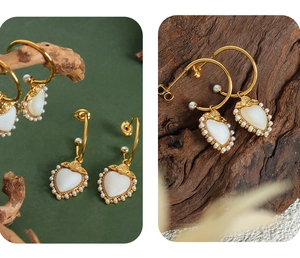 Macro detail of gold vintage heart earring with mother of pearl and floral relief