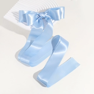 Detailed view of the smooth blue silk satin ribbon bow with long flowing streamers