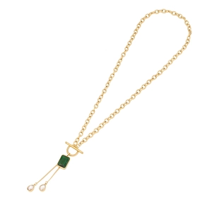 Golden T-bar necklace with a green rectangular gemstone and clear teardrop crystal tassels
