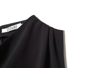 Close-up of black commuter vest neckline with ZEDERI label and fabric texture
