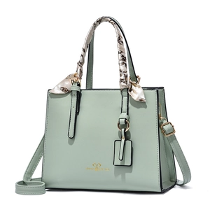 Light green fashion handbag with silk scarf handle and golden heart pattern engraving