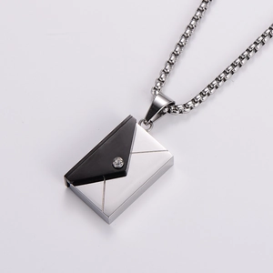 Macro detail of envelope pendant necklace in silver and black with cubic zirconia