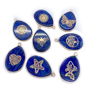 Eight teardrop lapis lazuli stone pendants with gold metal flower of life and bee patterns