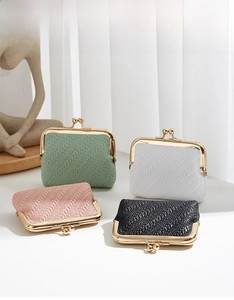 Detailed view of mini clasp wallets with woven texture in four pastel and neutral colors