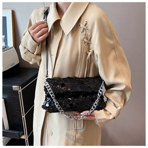 Detail showing high-end sequin texture and chunky silver chain on a black crossbody bag