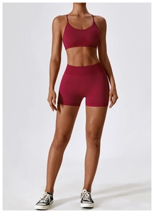 Detail view of seamless yoga bra and high waist shorts in deep burgundy stretch fabric