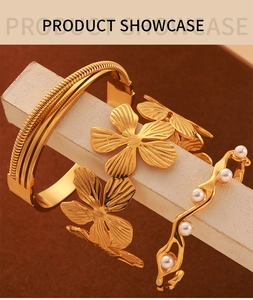 Detailed view of 18K gold plated textured bangle set with floral accents and pearls