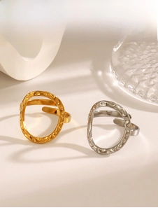 Close-up of gold and silver stainless steel rings featuring irregular lava hammer texture
