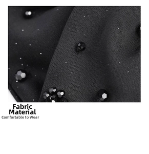 Detailed close-up of black satin bow hair claw with elegant faceted bead embellishments