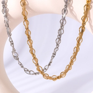 Interwoven 18k gold and silver plated stainless steel necklaces on a beige prop