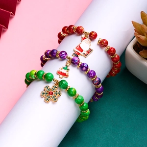 Detail of Christmas beaded bracelet set featuring Santa, tree and snowflake charms