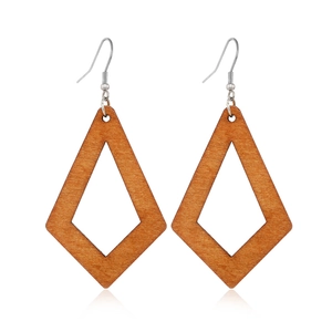Detailed view of hollow diamond-shaped wooden earrings with metallic hooks on white background