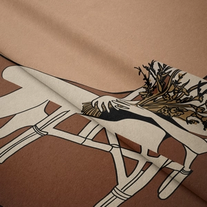 Close-up of artistic fabric tapestry with hand-drawn earth tone plant illustration