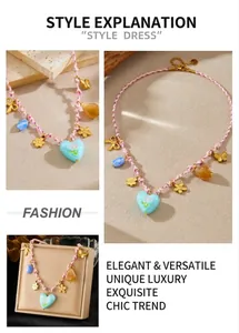 Detail of woven necklace featuring blue heart tulip pendant and gold metal butterfly charms