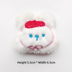White cartoon plush accessory with red hat embroidery, sized 5.5cm by 6.5cm detail view